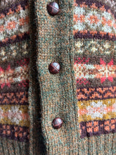 Close-up of a textured fabric with patterned design and buttons.