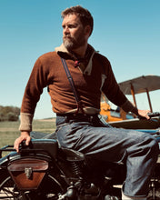 Man sitting on a vintage motorcycle wearing a 1920s Biker sweater