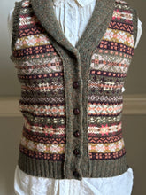 Knitted vest with a pattern on a mannequin against a neutral background