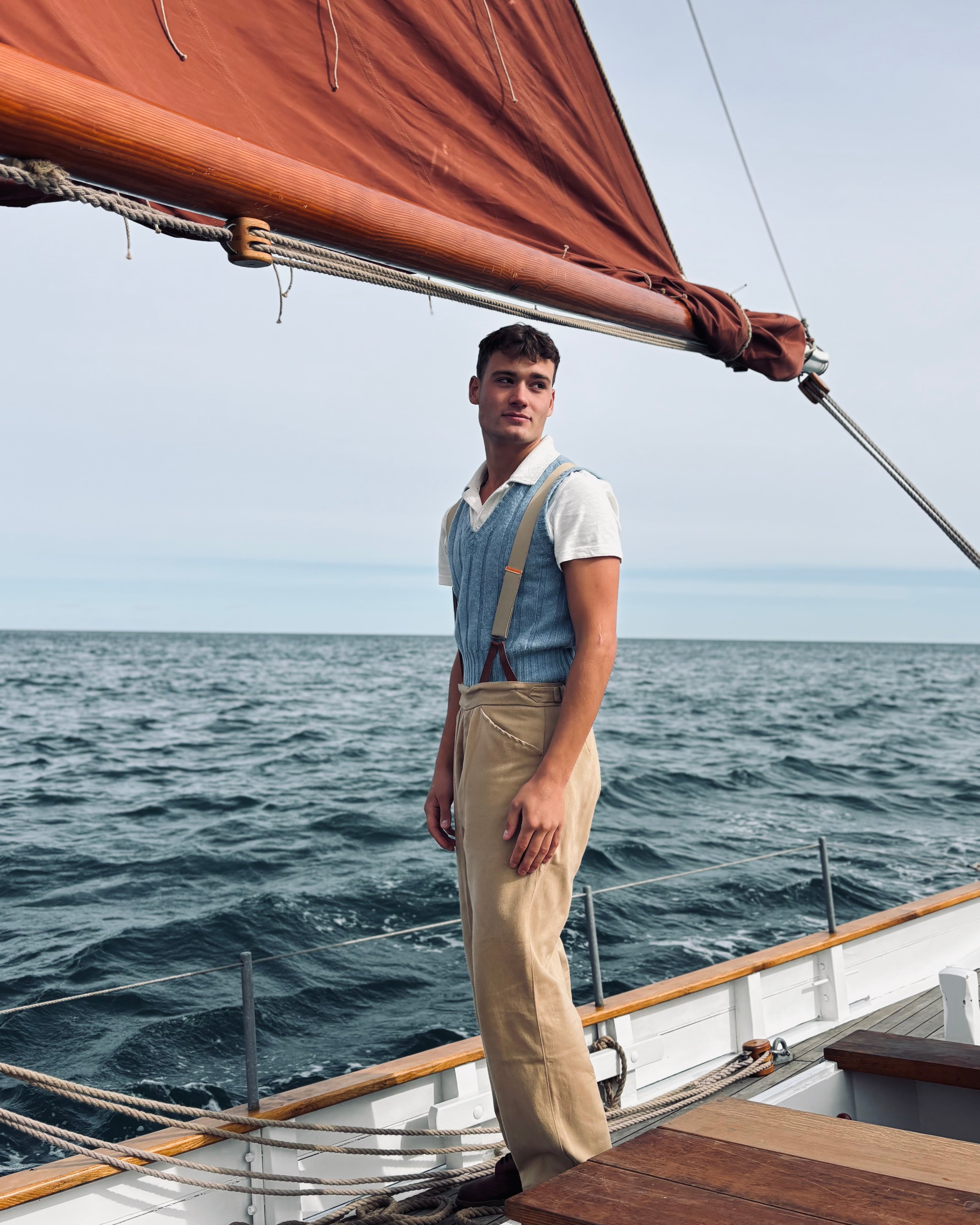 Man standing on a sailboat in the ocean