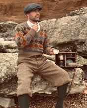 Man in vintage clothing drinking tea from a Drew & Sons En Route picnic set