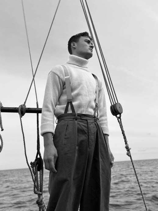 A vintage-style submariner polo neck sweater in ecru color with a ribbed cuff and classic nautical roll-neck.