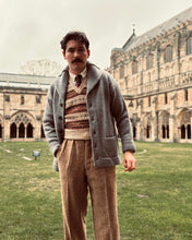 Man wearing a vintage fair isle tank top in front of a cathedral.
