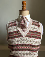 Knitted vest with a patterned collar on a mannequin against a neutral background