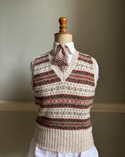 Textured sweater with patterned cuffs on a mannequin against a neutral background