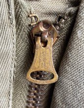 Close-up of a brass zipper pull on a Original US Army M-41 Field Jacket